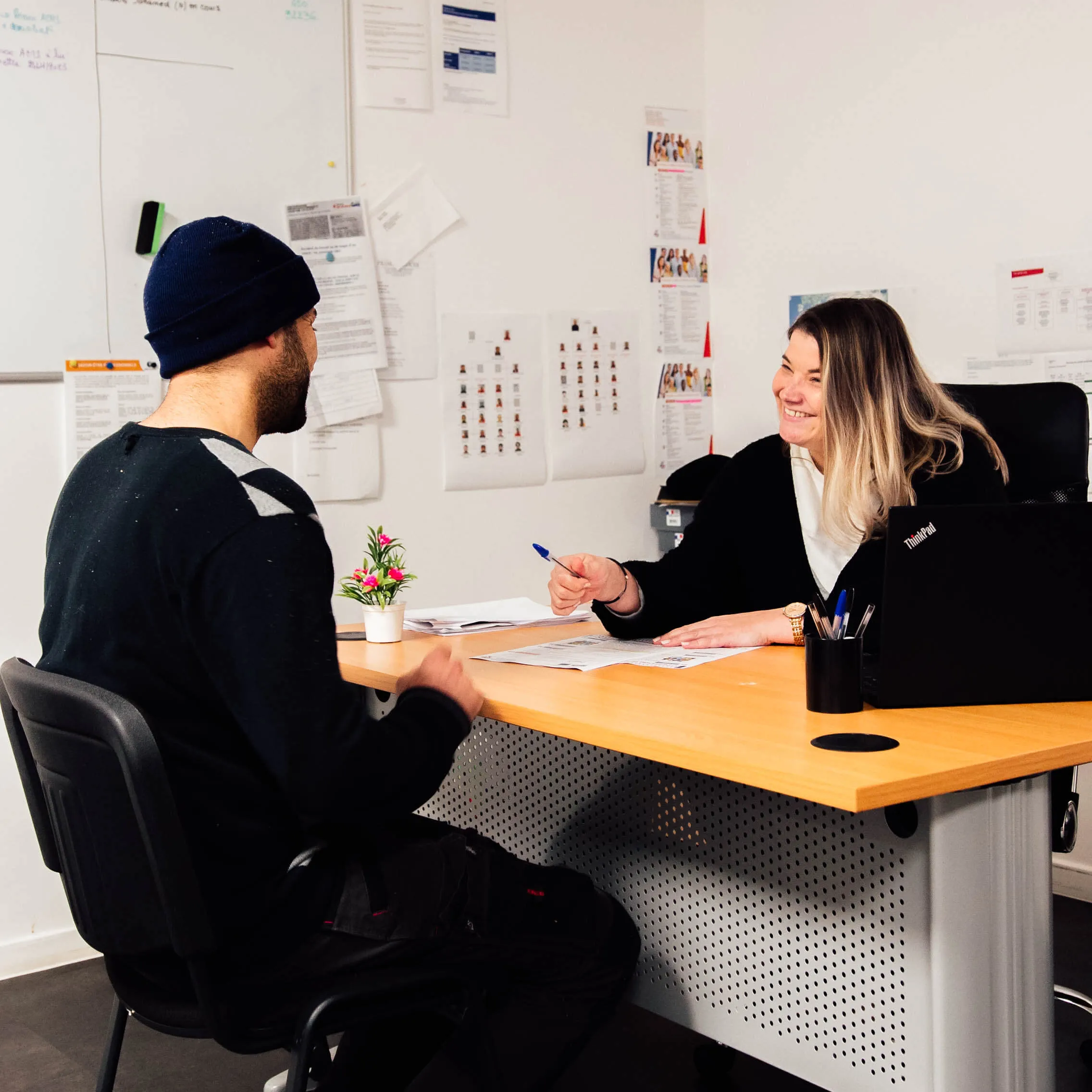 Photo of two people talking around a desk